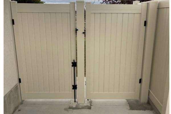 backyard gate repair next to vinyl fence